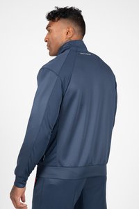 Marineblauwe sportjack met hoge kraag, gestructureerde zijkanten en elastische manchetten. Soepele stof met contrasterende meshdetails.