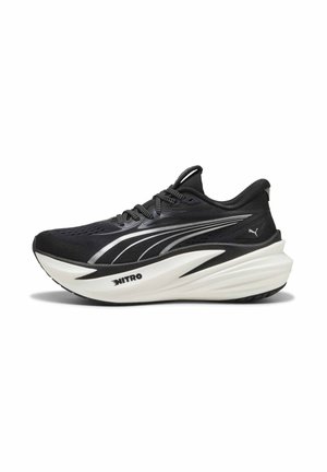 Black and white Puma running shoe with thick sole, silver stripes, "Nitro" branding on midsole, and lace-up closure, side view.