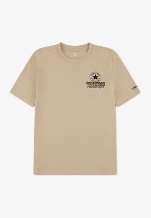 Beige cotton t-shirt with short sleeves, featuring a round neckline and a black graphic logo on the left chest and sleeve.