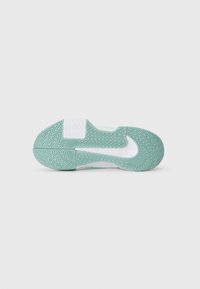 Suela de zapatilla blanca y verde menta con un patrón de banda de rodadura en zigzag y un gran logotipo de Nike en blanco centrado.
