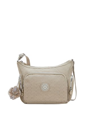 Beige Schultertasche mit einem gesteppten Muster, silbernen Reißverschlüssen, einem Logo-Patch und einem abnehmbaren Affen-Schlüsselanhänger. Verstellbarer Riemen inklusive.