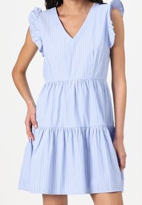 Hellblau gestreiftes Kleid mit V-Ausschnitt, Rüschensäumen und einem schichtweisen, ausgestellten Rock. Hergestellt aus einem glatten Stoff mit weicher Textur.