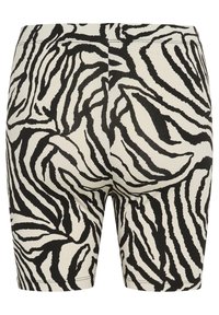 Leggingi sa uzorkom zebre u crnoj i krem boji, koji imaju uski kroj, glatku teksturu i kratku dužinu.