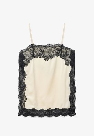 Kreemikas satiinist kampsun õhukeste rihmadega, millel on musta lillesatsiga pitsi äär topi, külgede ja ääre peal.