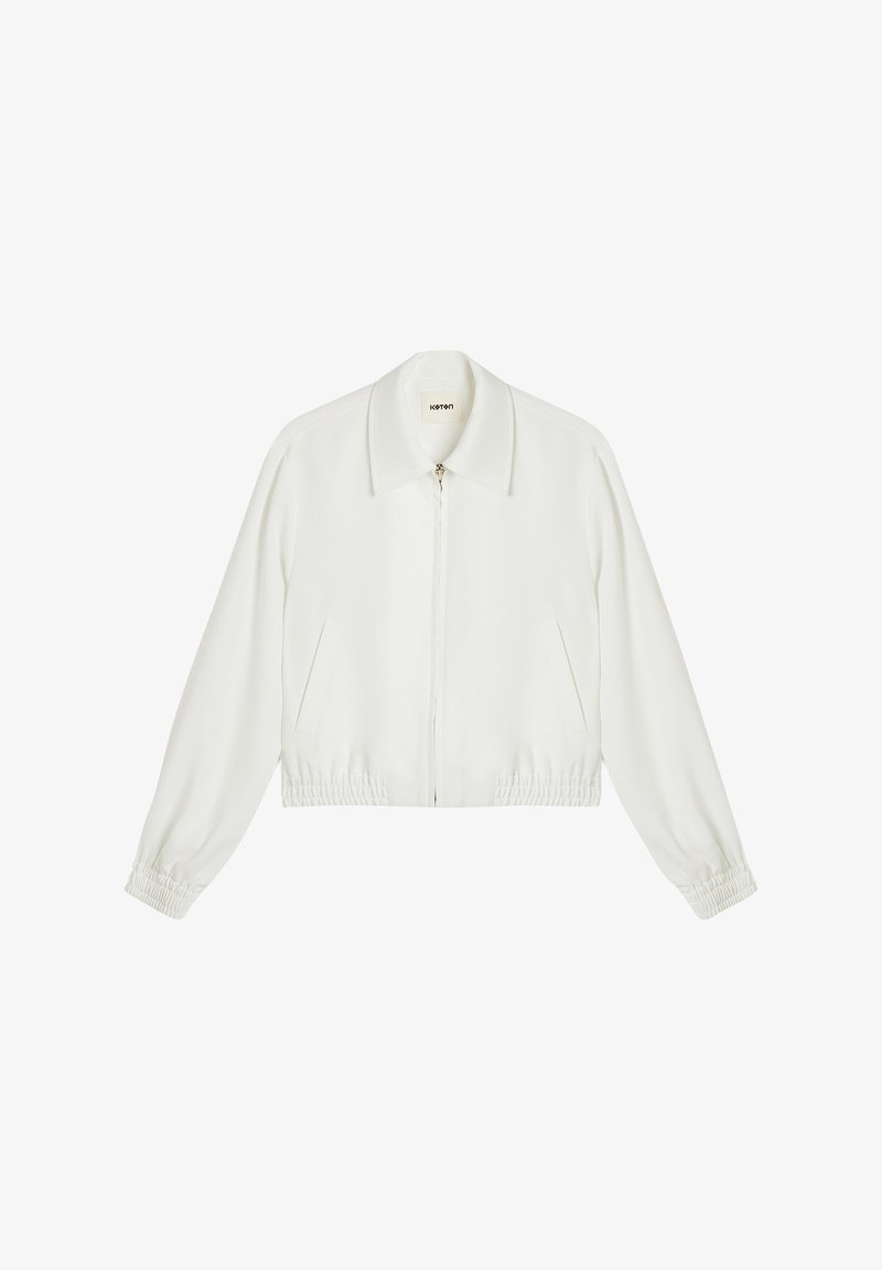 Klippe hvid jakke med krave, lynlås foran, elastiske ærmer og sidelommer. Glat tekstur og minimalistisk design.
