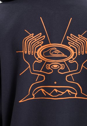 Navy sweatshirt featuring an orange graphic design of hands and a person with a mountain backdrop, highlighting intricate line work.
