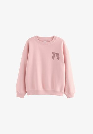 Pink cotton sweatshirt with ribbed cuffs and hem, featuring a small striped bow graphic on the left chest area. Round neckline, relaxed fit.