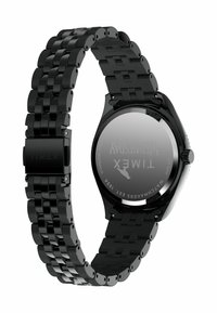 Mustmust terasest kell, millel on tekstuuriga, paindlik rihm ja ümar korpus. Tagaküljel on graveeritud "Timex" ja muid üksikasju.
