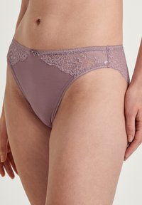 Porcellana leggera con dettagli in pizzo floreale in vita, tessuto morbido e taglio classico che enfatizza comfort e vestibilità.