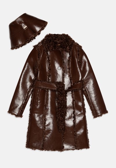 Brown glossy leather coat with a textured brown fluffy collar and trim, cinched waist with a matching belt, accompanied by a hat.