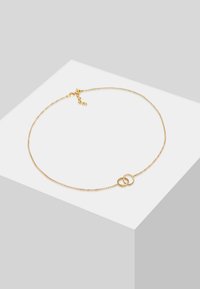 Collana in oro con due anelli circolari interconnessi al centro. Presenta una texture delicata con perline e una chiusura a gancio.