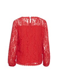 Red lace long-sleeve top featuring a scalloped hem and a button closure at the back. Delicate floral pattern throughout. Semi-transparent.