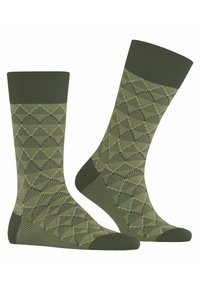 Knielange Socken in Dunkelgrün mit einem geometrischen Rautenmuster in Hellgrün. Hergestellt aus einem strukturierten Stoff, mit gerippten Abschlüssen.