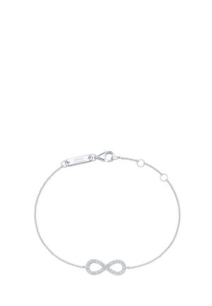 Delicate silver infinity bracelet with small embedded crystals and a lobster clasp, branded Giorgio Martella on a small tag near the clasp.