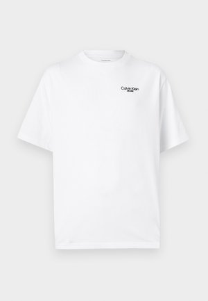 White cotton t-shirt with a crew neckline and short sleeves. Features a black "Calvin Klein Jeans" logo on the upper left chest.