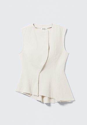 Sleeveless beige top with a unique asymmetric hem and textured fabric. Features a front overlap design, raw edges, and a subtle sheen.