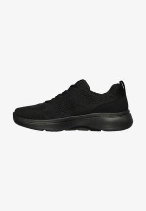 Black athletic shoes with a textured mesh upper, sleek rubber sole, and lace-up design. Features a subtle heel tab for easy wear.