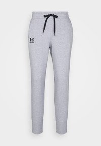 Grijze katoenen joggingbroek met zijzakken, elastische tailleband en zwarte trekkoord. Heeft een zwart logo op het linkerbeen. Tapered beenontwerp.