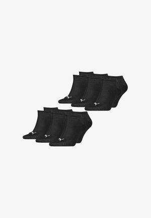 Zehn Paare schwarze, flache Socken mit kleinen weißen Puma-Logos an den Zehen, angeordnet in zwei überlappenden Reihen.