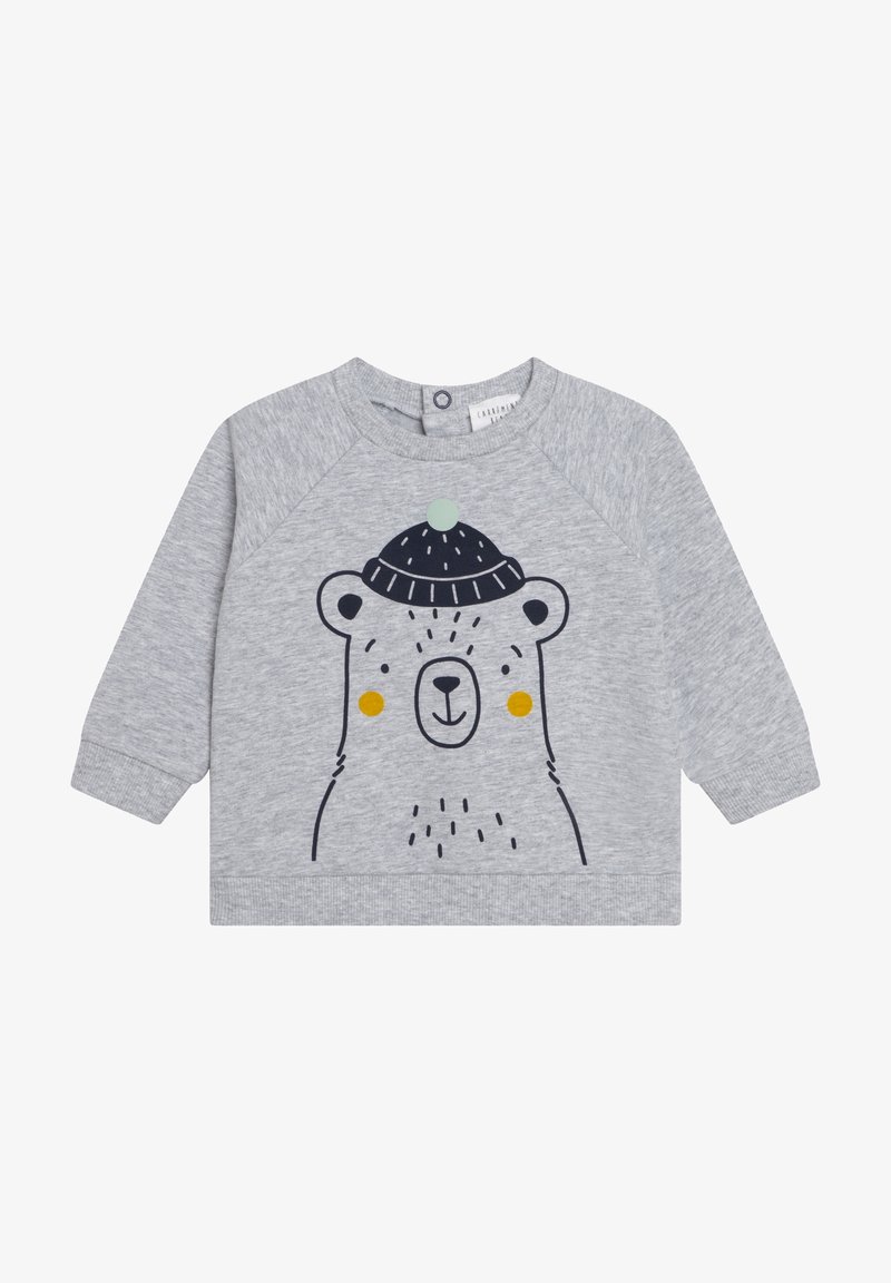 Pull bébé à manches longues gris clair avec un visage d'ours noir simple portant un bonnet bleu foncé tricoté avec un pompon vert et des joues jaunes.