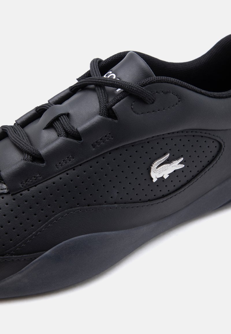 Black leather sneaker with perforated sides, black laces, and a white crocodile logo on the side panel.