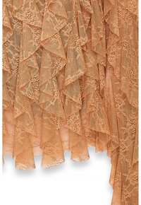 Beige layered lace fabric with floral patterns and scalloped edges, arranged in ruffled, overlapping folds.