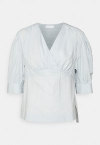 Lyseblå, kortermet topp med v-hals og plissédesign. Laget av glatt stoff, med puffede ermer og sidesplitter.