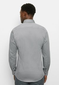 Gray long-sleeve shirt with a textured pattern, tailored fit, and buttoned cuffs. Features a classic collar and back yoke design.
