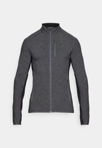 Šedá sportovní bunda s vysokým límcem, dlouhými rukávy a kontrastními černými bočními panely; obsahuje přední zip a strukturovanou tkaninu.