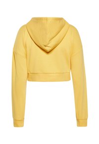 Zkrácená žlutá mikina vyrobená z měkké bavlny, s dlouhými rukávy, kapucí na šňůrku a žebrovanými manžetami, s minimalistickým designem.