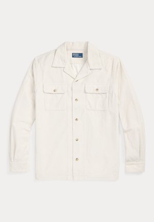 Chemise en velours côtelé crème à manches longues avec deux poches poitrine à boutons et un col italien.