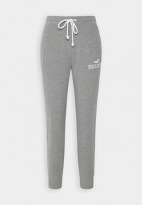 Grå sweatpants med ribbad mudd, vit snörning i midjan och vit Hollister-logga på övre vänstra låret.