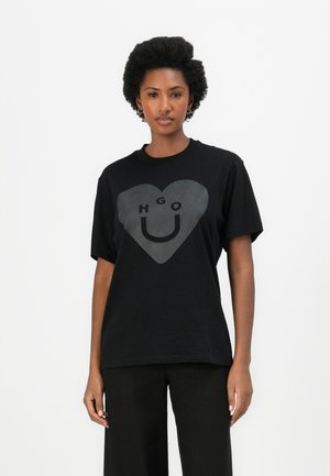 Black cotton t-shirt featuring a large heart graphic with the text "HGO U" in the center. Short sleeves and a crew neckline.