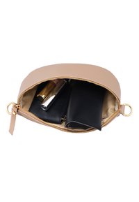 Beige zippered pouch open to show black wallet, black sunglasses case, and two tubes of lipstick inside.