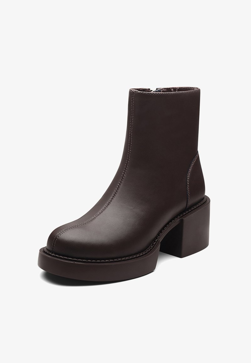 Brown leather ankle boot with a chunky heel, rounded toe, visible stitching, and a smooth texture. Side zip for easy wear.