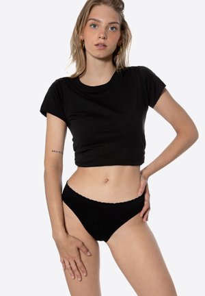 Black cropped t-shirt and matching black briefs, featuring a scalloped waistband, soft texture, and fitted design.