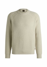 Maglione a maglia beige chiaro con un motivo testurizzato, scollatura rotonda e polsini e orlo a costine. Presenta un piccolo etichetta del marchio sul collare.