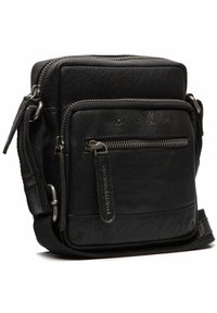 Sac bandoulière en cuir noir avec une finition texturée, des compartiments zippés et des accents en métal. Design compact et carré.