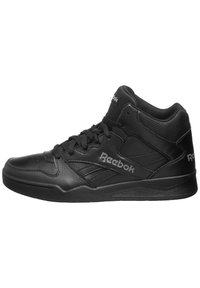 Černé vysoké tenisky vyrobené z texturované kůže, s polstrovaným límcem, černými šňůrkami a stříbrnými akcenty s logem Reebok.