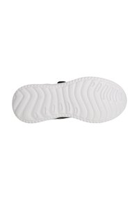 Schwarze Schuhsohle mit einer strukturierten weißen Gummisohle, die ein Wellenmuster für Grip und Traktion aufweist. Die Kanten sind glatt und das Design ist langlebig.