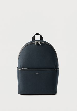 Compact dark blue backpack with front zip pocket, silver zippers, a top handle, and small "BOSS" logo on the front pocket.