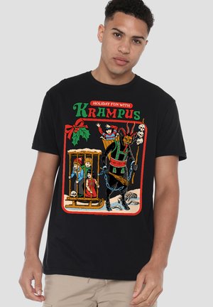 Man wearing black T-shirt showing Krampus pulling a sled with children in a cage and holding a staff with skulls, text "Holiday Fun with Krampus."