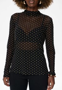 Zwarte lange mouwen mesh top met gouden polka dots, voorzien van een hoge halslijn en een nauwsluitend ontwerp. Doorzichtig materiaal met een gladde textuur.