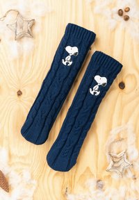 Scaldamuscoli lavorati a maglia blu navy con motivo a treccia, caratterizzati da un design ricamato di Snoopy bianco sul lato. Texture morbida e vestibilità aderente.