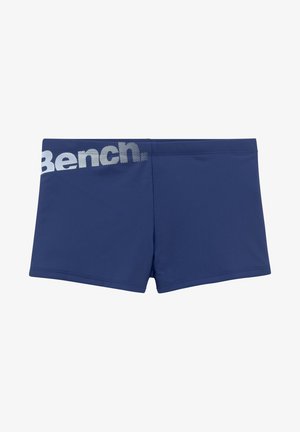 Námornícke modré plavecké šortky s elastickým pásom, hladkou textúrou a bielym logom "Bench." potlačeným na ľavej strane.