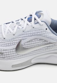 Gray and white Nike athletic shoe with mesh upper and silver swoosh. Features flat white laces and a cushioned sole for comfort.
