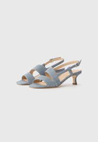 Light blue suede slingback sandals feature a low heel, open toe, and intersecting straps across the front. Adjustable ankle strap included.