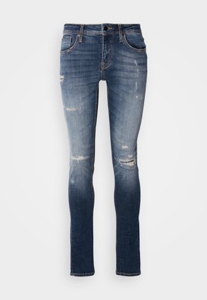 Blue denim skinny jeans with slight fading and distressed details. Features five pockets and contrast stitching along the seams.