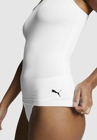 White cotton tank top featuring a form-fitting design, adjustable straps, and a black Puma logo on the lower side.