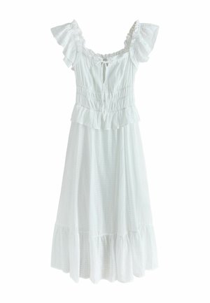 Robe blanche longueur genou avec manches épaules dénudées à volants, corsage froncé, nouée à l'avant, et jupe à volants superposés.